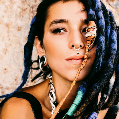 Millennial woman with face piercings and dreadlocks