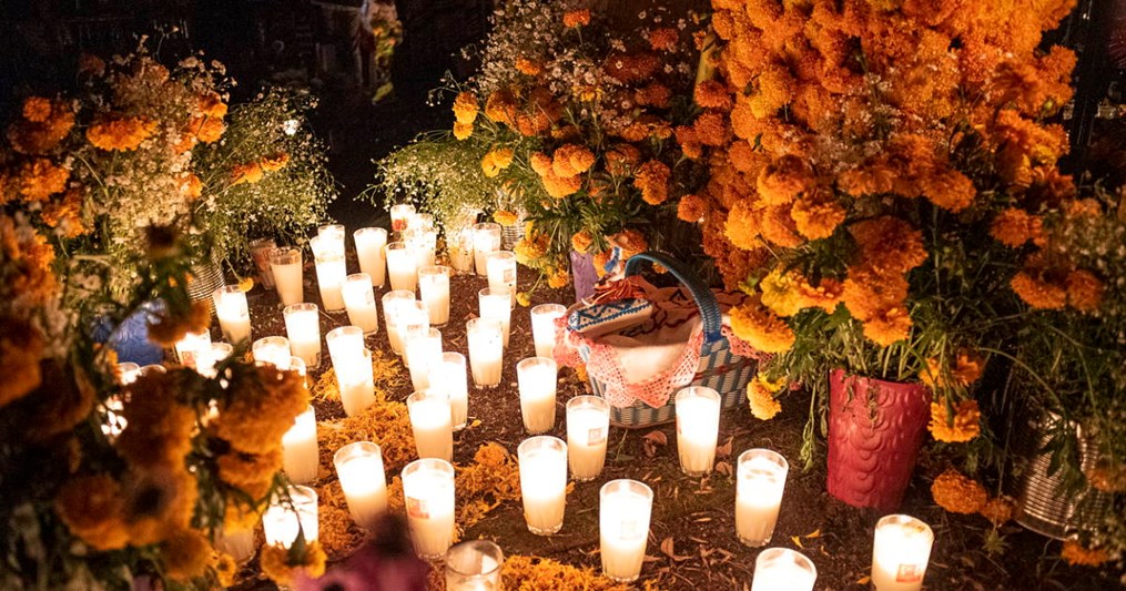 You can use traditional marigolds and candles as a way to celebrate lost loved ones during the Day of the Dead.
